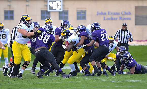 Devin Gardner (98), Mason Cole (52), Kyle Kalis (67), and De'Veon Smith (4)