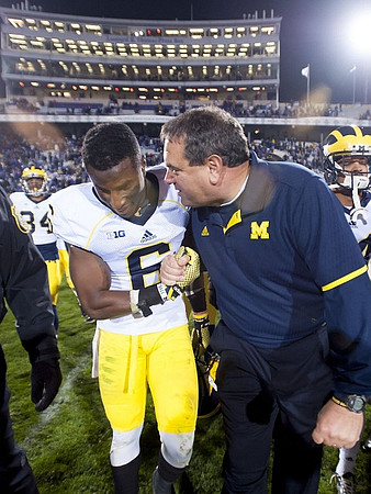 Jeremy Clark (34), Raymon Taylor (6), and Brady Hoke