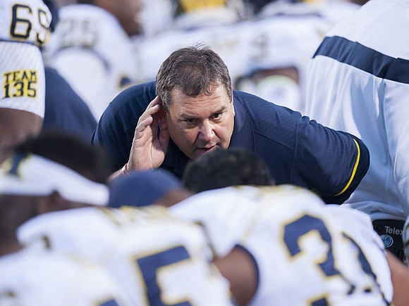 Willie Henry (69) and Brady Hoke