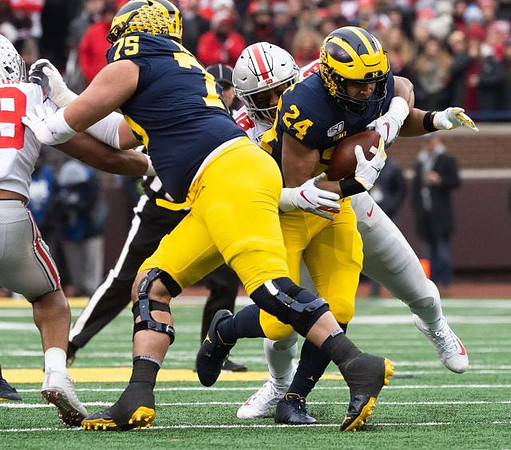 Jon Runyan Jr. (75) and Zach Charbonnet (24)