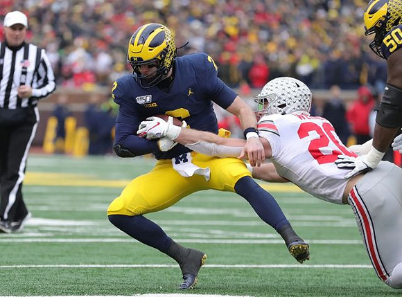 Shea Patterson (2) and Michael Onwenu (50)