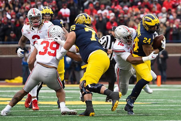 Jon Runyan Jr. (75) and Zach Charbonnet (24)