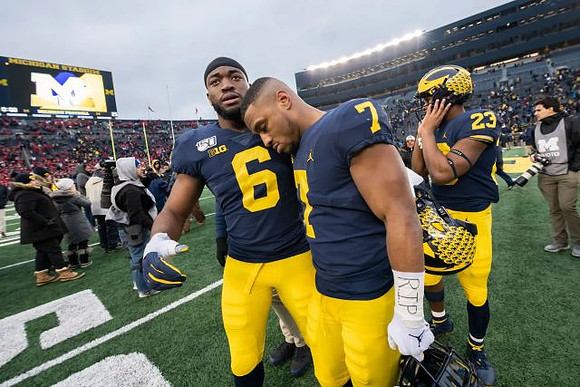 Josh Uche (6), Khaleke Hudson (7), and Michael Barrett (23)