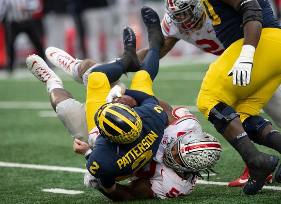 Shea Patterson (2) and Michael Onwenu (50)