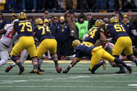 Jon Runyan Jr. (75), Ben Bredeson (74), Shea Patterson (2), Zach Charbonnet (24), and Cesar Ruiz (51)