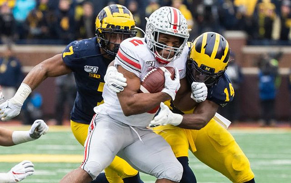 Khaleke Hudson (7) and Josh Metellus (14)