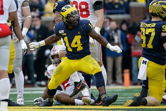 Josh Metellus (14), Khaleke Hudson (7), and Aidan Hutchinson (97)