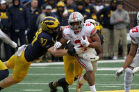 Aidan Hutchinson (97) and Josh Metellus (14)