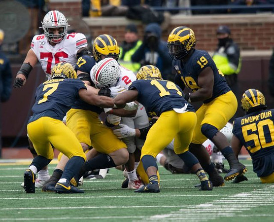 Khaleke Hudson (7), Aidan Hutchinson (97), Josh Metellus (14), Kwity Paye (19), and Michael Dwumfour (50)