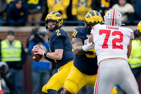 Shea Patterson (2) and Cesar Ruiz (51)
