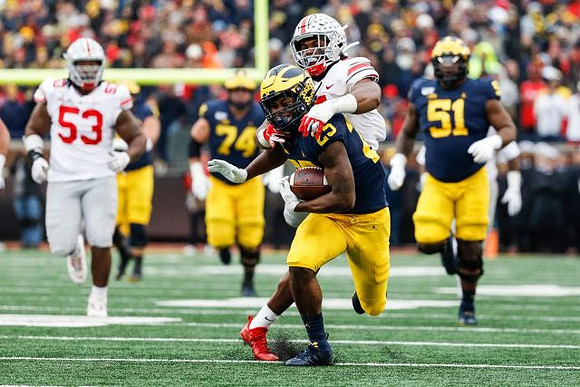 Hassan Haskins (25), Ben Bredeson (74), and Cesar Ruiz (51)