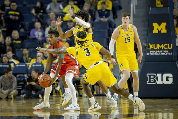 Zavier Simpson (3), Eli Brooks (55), and Jon Teske (15)