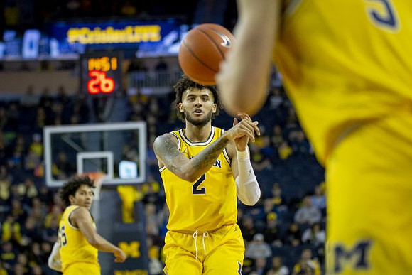 Eli Brooks (55), Isaiah Livers (2), and Zavier Simpson (3)