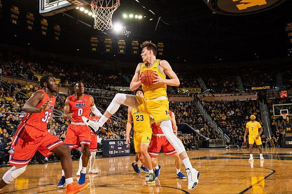 Colin Castleton (11), Brandon Johns Jr. (23), and Zavier Simpson (3)
