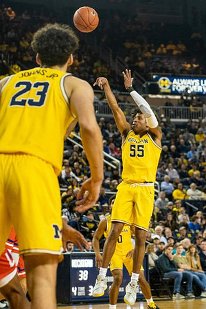 Brandon Johns Jr. (23), Eli Brooks (55), and David DeJulius (0)
