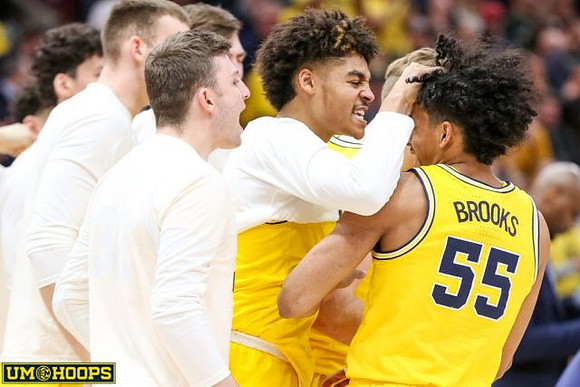 Ignas Brazdeikis (13) and Michigan Team