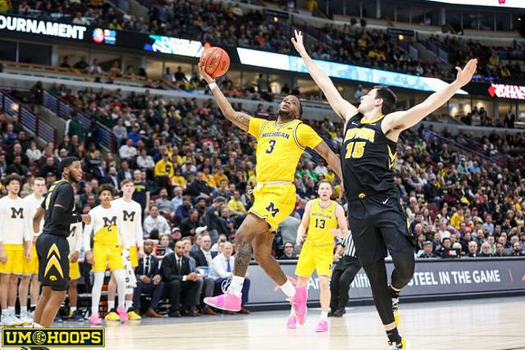Eli Brooks (55) and Michigan Team