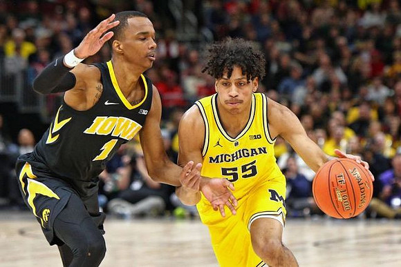 Isaiah Livers (4), Eli Brooks (55), and Jon Teske (15)