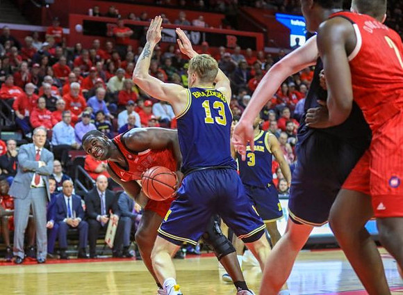 Ignas Brazdeikis (13), Zavier Simpson (3), Jon Teske (15), and Rutgers Head Coach Steve Pikiell