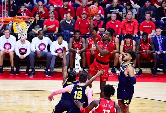 Zavier Simpson (3), Jon Teske (15), and Isaiah Livers (4)