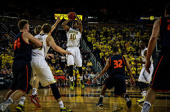 Mark Donnal (34), Derrick Walton Jr., and Caris LeVert (23)