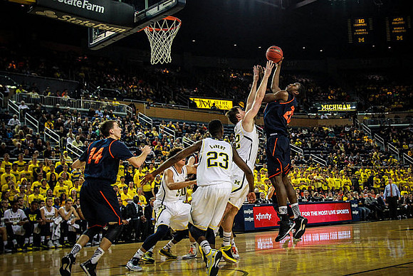 D.J. Wilson (5), Caris LeVert (23), and Ricky Doyle (32)