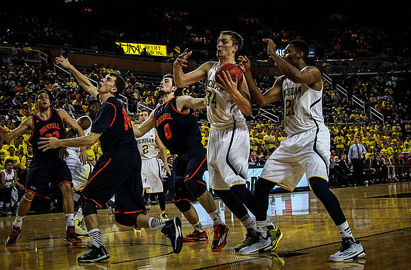 Spike Albrecht (2), Mark Donnal (34), and Zak Irvin (21)