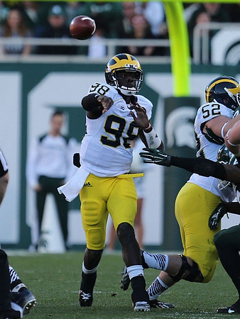 Devin Gardner (98) and Mason Cole (52)