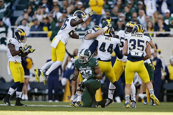 Raymon Taylor (6), Jourdan Lewis (26), Jake Ryan (47), Delano Hill (44), Frank Clark (57), and Joe Bolden (35)