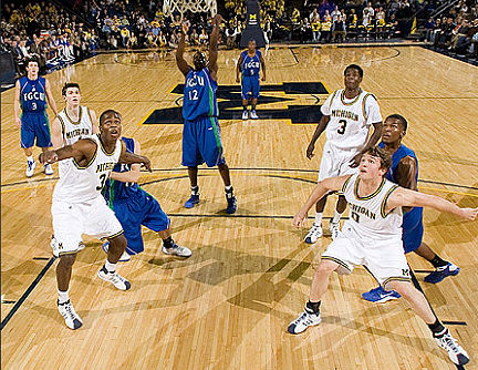 DeShawn Sims (34), Zack Novak (0), Stu Douglass (1), and Manny Harris (3)