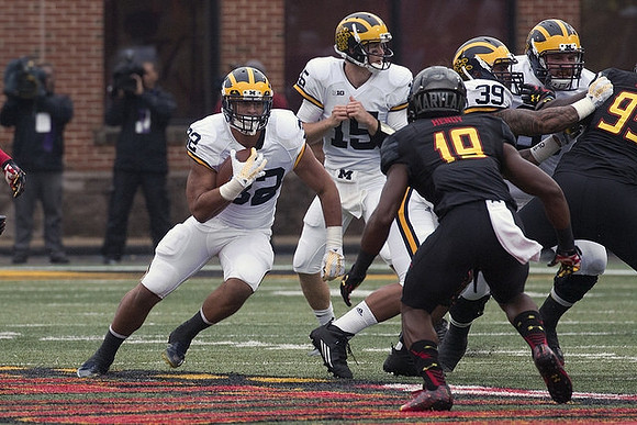 Ty Isaac (32), Jake Rudock (15), and Sione Houma (39)