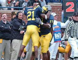 Jeremy LeSueur (21), Larry Stevens (13), and Kirk Ferentz