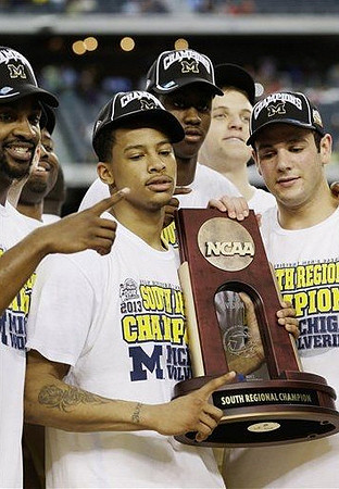 Corey Person (32), Trey Burke (3), Glenn Robinson III (1), Josh Bartelstein (20), and Max Bielfeldt (44) with South Regional Championship Trophy