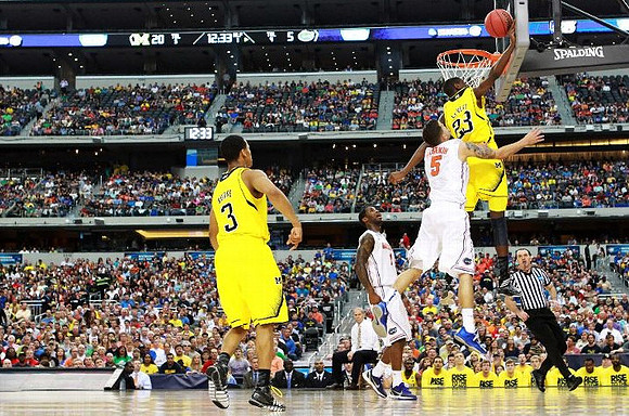 Trey Burke (3), Caris LeVert (23), and John Beilein