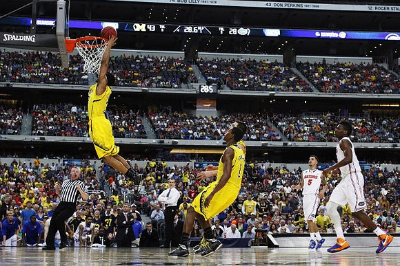 Trey Burke (3), Glenn Robinson III (1), and Florida Head Coach Billy Donovan