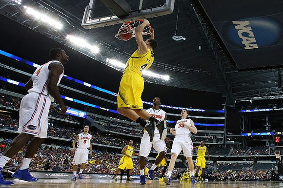 Mitch McGary (4), Trey Burke (3), and Glenn Robinson III (1)