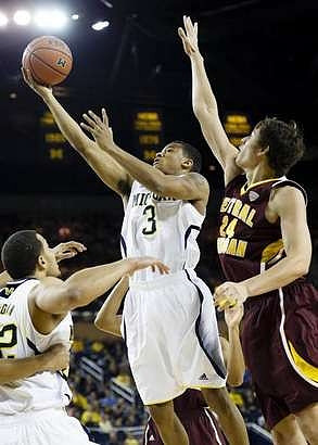 Jordan Morgan (52) and Trey Burke (3)