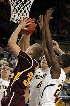 Nik Stauskas (11), Mitch McGary (4), and Caris LeVert (23)