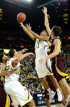Jordan Morgan (52) and Trey Burke (3)