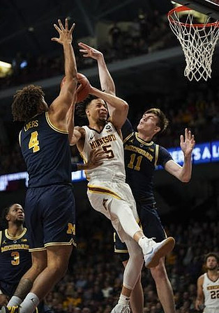 Zavier Simpson (3), Isaiah Livers (4), and Colin Castleton (11)