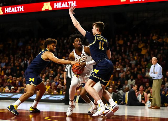 Isaiah Livers (4), Colin Castleton (11), and John Beilein