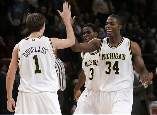 Stu Douglass (1), DeShawn Sims (34), and Manny Harris (3)