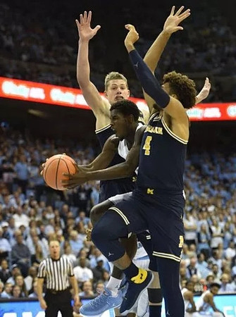 Moritz Wagner (13) and Isaiah Livers (4)