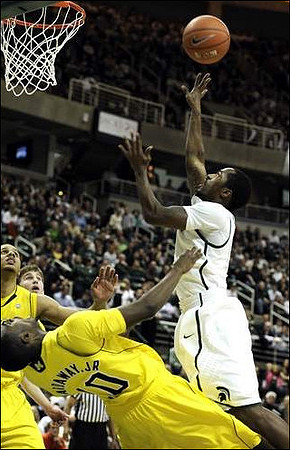 Tim Hardaway Jr. (10), Jordan Morgan (52), and Evan Smotrycz (23)