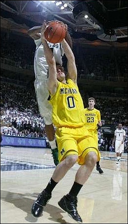 Zack Novak (0) and Evan Smotrycz (23)