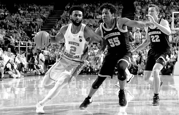 Eli Brooks (55) and Duncan Robinson (22)