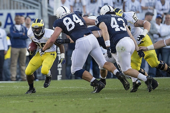 Fitzgerald Toussaint (28) and Kyle Kalis (67)