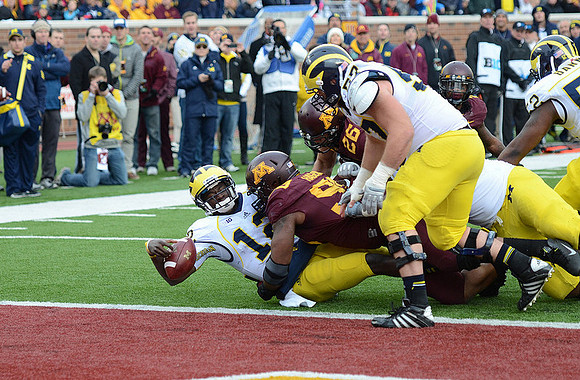 Devin Gardner (12), Taylor Lewan (77), and Ricky Barnum (52)
