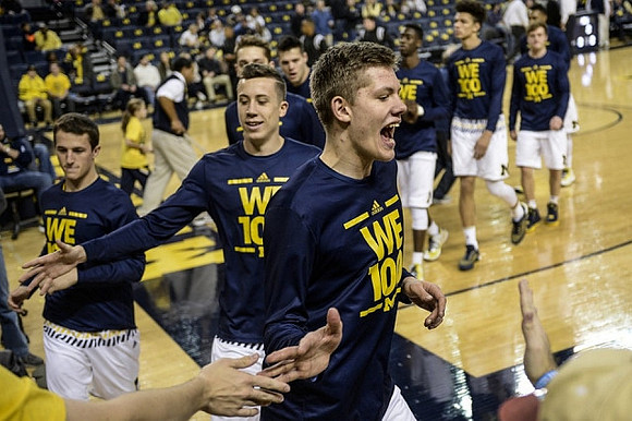 Andrew Dakich (11), Duncan Robinson (22), and Moritz Wagner (13)