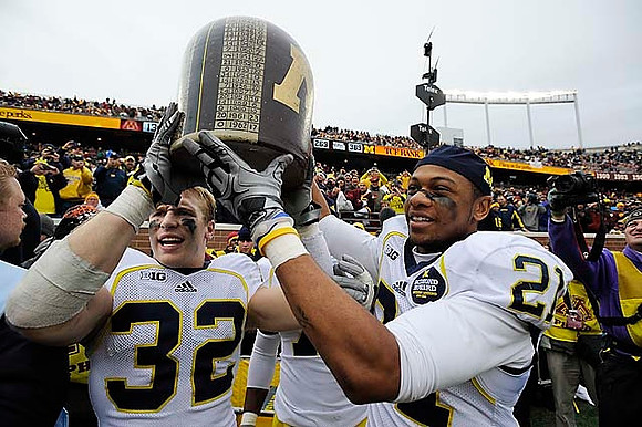 Jordan Kovacs (32), The Little Brown Jug, and Roy Roundtree (21)